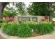 Entrance sign for Bentley Park featuring lush landscaping, shrubbery, and trees at 3177 Montrose Pl, Palm Harbor, FL 34684