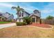 Stylish exterior featuring brick accents, a two-car garage, and professional landscaping at 3177 Montrose Pl, Palm Harbor, FL 34684