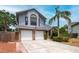 Charming two-story home featuring a two-car garage, landscaped yard, and beautiful architectural details at 3177 Montrose Pl, Palm Harbor, FL 34684
