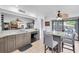 View of open kitchen and bar area with stainless steel dishwasher and granite countertops at 3177 Montrose Pl, Palm Harbor, FL 34684