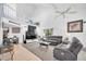 Spacious living room featuring high ceilings, a ceiling fan, plush seating, and a lofted area at 3177 Montrose Pl, Palm Harbor, FL 34684