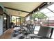 This covered patio boasts ample seating, grill and a ceiling fan, making it an ideal spot for outdoor gatherings at 3177 Montrose Pl, Palm Harbor, FL 34684