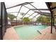 Enjoy the outdoors year-round with this inviting screened-in pool with poolside basketball hoop and in-pool floatation at 3177 Montrose Pl, Palm Harbor, FL 34684