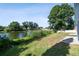 Lush backyard with a serene lake view and access to the water's edge at 3238 Cullendale Dr, Tampa, FL 33618