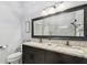 Bathroom featuring dual sinks, a granite countertop, a large mirror, and modern fixtures at 3238 Cullendale Dr, Tampa, FL 33618