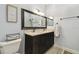 Bathroom featuring dual sinks, a large framed mirror, and modern fixtures at 3238 Cullendale Dr, Tampa, FL 33618