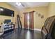 This bedroom offers dark hardwood floors and large window and ceiling fan, creating a cozy and comfortable private space at 3238 Cullendale Dr, Tampa, FL 33618