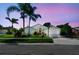 Inviting single-Gathering home with lush landscaping and twilight sky, with a well maintained lawn and mature palm trees at 3238 Cullendale Dr, Tampa, FL 33618