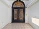 Elaborate black double front doors with ornate carved transom and tiled entryway at 3238 Cullendale Dr, Tampa, FL 33618