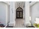 Impressive arched double front doors framed by white columns and decorative lighting at 3238 Cullendale Dr, Tampa, FL 33618