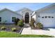 Elegant home entrance with decorative front door, lush landscaping, and manicured lawn at 3238 Cullendale Dr, Tampa, FL 33618