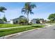 Lovely home with a green lawn, mature palm trees, and a basketball hoop at 3238 Cullendale Dr, Tampa, FL 33618