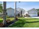 Beautiful home with a well-manicured lawn, lush landscaping, and a two-car garage at 3238 Cullendale Dr, Tampa, FL 33618