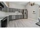 Kitchen featuring gray cabinetry, marble backsplash, and stainless steel appliances at 3238 Cullendale Dr, Tampa, FL 33618