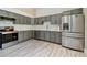 Spacious kitchen with stainless steel appliances, gray cabinets and marbled backsplash at 3238 Cullendale Dr, Tampa, FL 33618