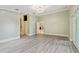 This living room features light vinyl floors, white walls, and multiple doors to other rooms at 3238 Cullendale Dr, Tampa, FL 33618