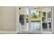 Enclosed patio with tile floor features a pizza oven and stainless steel refrigerator at 3238 Cullendale Dr, Tampa, FL 33618