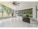 Spacious screened patio with a ceiling fan, outdoor kitchen features, and roll-down blinds at 3238 Cullendale Dr, Tampa, FL 33618
