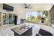Covered patio features tile flooring, outdoor kitchen area, a pizza oven, and screened-in porch with view at 3238 Cullendale Dr, Tampa, FL 33618