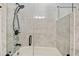 Modern shower with white marble tile, glass door, and sleek hardware at 3238 Cullendale Dr, Tampa, FL 33618