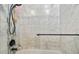 Luxurious marble tiled shower featuring a rainfall showerhead and sleek black fixtures at 3238 Cullendale Dr, Tampa, FL 33618