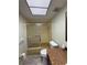 Bathroom featuring a bathtub with a shower, a toilet, and vanity with a textured countertop at 3411 Teeside Dr, New Port Richey, FL 34655