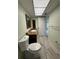 Well-lit bathroom featuring wood-look tile flooring and a granite-topped vanity at 3411 Teeside Dr, New Port Richey, FL 34655