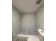 Updated bathroom featuring a tiled shower with a rainfall showerhead and stylish mosaic floor at 3411 Teeside Dr, New Port Richey, FL 34655