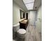 Well-lit bathroom featuring wood-look tile flooring and a granite-topped vanity at 3411 Teeside Dr, New Port Richey, FL 34655