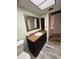 Well-lit bathroom featuring wood-look tile flooring and a granite-topped vanity at 3411 Teeside Dr, New Port Richey, FL 34655