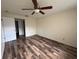 Bedroom featuring wood floors, neutral walls, and ceiling fan at 3411 Teeside Dr, New Port Richey, FL 34655