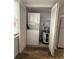 Convenient laundry area with stacked washer and dryer, plus additional storage space at 3411 Teeside Dr, New Port Richey, FL 34655