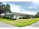 Back of the home featuring a well-manicured lawn and landscaping at 3411 Teeside Dr, New Port Richey, FL 34655