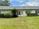 Exterior backyard featuring lawn and small palm tree at 3411 Teeside Dr, New Port Richey, FL 34655