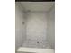 Modern shower with stylish white tile and mosaic tile floor at 3411 Teeside Dr, New Port Richey, FL 34655