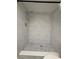 Newly renovated shower featuring sleek marble-look tiling, a rainfall showerhead, and modern fixtures at 3411 Teeside Dr, New Port Richey, FL 34655