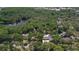 An aerial perspective showing the neighborhood with lush trees, with a lake to add to its scenic beauty at 3906 Floyd Rd, Tampa, FL 33618
