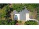 An aerial perspective of a home with a screened pool and a well-maintained roof, surrounded by trees at 3906 Floyd Rd, Tampa, FL 33618