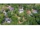 A scenic aerial view showcasing multiple homes nestled among lush green trees in the neighborhood at 3906 Floyd Rd, Tampa, FL 33618