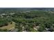 An aerial view of a lush green neighborhood with a pond and homes scattered throughout the trees at 3906 Floyd Rd, Tampa, FL 33618