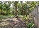 The backyard is wooded with plenty of trees and shade and bordered by a fence at 3906 Floyd Rd, Tampa, FL 33618