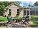 Backyard features a stone patio, exterior of the home, and a screened-in porch at 3906 Floyd Rd, Tampa, FL 33618