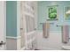Well-lit bathroom featuring a tub/shower combination with a modern shower curtain and fresh decor at 3906 Floyd Rd, Tampa, FL 33618