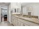 Spacious bathroom with dual sinks, granite countertops, and elegant fixtures at 3906 Floyd Rd, Tampa, FL 33618