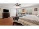 Bedroom featuring hardwood floors, plantation shutters, and en suite closet at 3906 Floyd Rd, Tampa, FL 33618