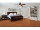 Bright bedroom with hardwood floors, ensuite bathroom, and built in bookcase at 3906 Floyd Rd, Tampa, FL 33618