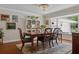 Charming dining room with a wooden table, chandelier, and a large bay window at 3906 Floyd Rd, Tampa, FL 33618