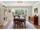 Elegant dining room with chandelier lighting, a large window, and hardwood floors at 3906 Floyd Rd, Tampa, FL 33618