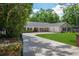 Well-maintained home with mature landscaping, a spacious driveway, and an inviting front entrance at 3906 Floyd Rd, Tampa, FL 33618