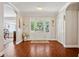 Elegant foyer with hardwood floors, a glass-paneled door, and classic white trim at 3906 Floyd Rd, Tampa, FL 33618